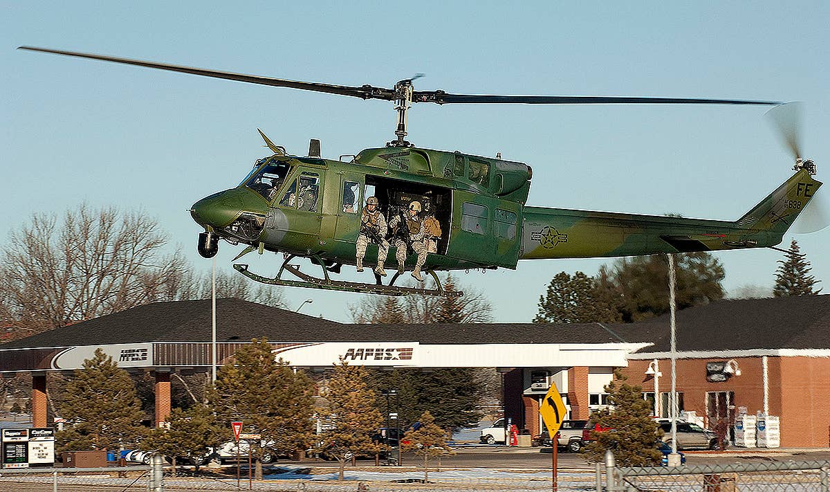 111213-f-fw079-098_90th_security_forces_group_prepare_to_jump_out_of_uh-1n_at_warren.jpg
