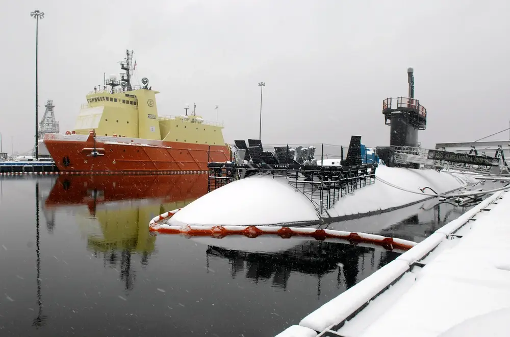The Los Angeles class fast attack submarine USS Alexandria and the Submarine Support Vessel Carolyn Chouest sit covered in snow on a blustery, snowy day at Naval Submarine Base New London in Groton. Photo by&nbsp;<a href="https://www.dvidshub.net/portfolio/1104431/john-narewski">Seaman John Narewski</a>.