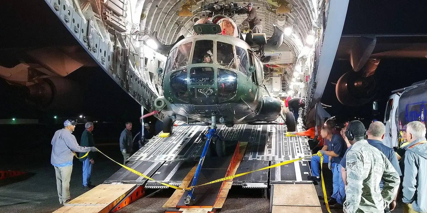 An Afghan Air Force Mi-17 helicopter is loaded into a cargo plane. The US government has considered transferring ex-Afghan Air Force Mi-17s to the Ukrainian military.
