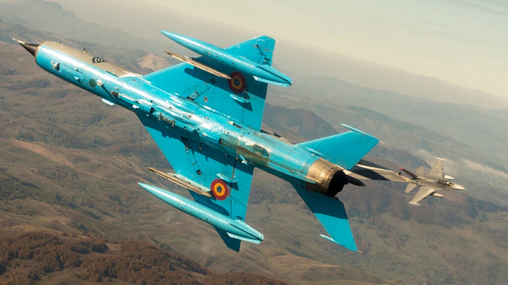Alabama Air National Guard F-16 Fighting Falcons fly in formation with Romanian Air Force MiG-21 Lancers during a training mission near 71st Air Base, Campia Turzii, Romania, during Exercise Dacian Viper, Oct. 23, 2015. Four F-16 Fighting Falcons and approximately 150 Airmen from the 187th Fighter Wing are participating in Dacian Viper, a training deployment to Romania designed to increase readiness to conduct combined air operations and to meet future security challenges. The ANG State Partnership Program supports combatant commander and embassy security cooperation objectives by pairing a state's National Guard with a partner nation's military. (U.S. Air Force photo by Staff Sgt. Matthew Bruch/Released)
