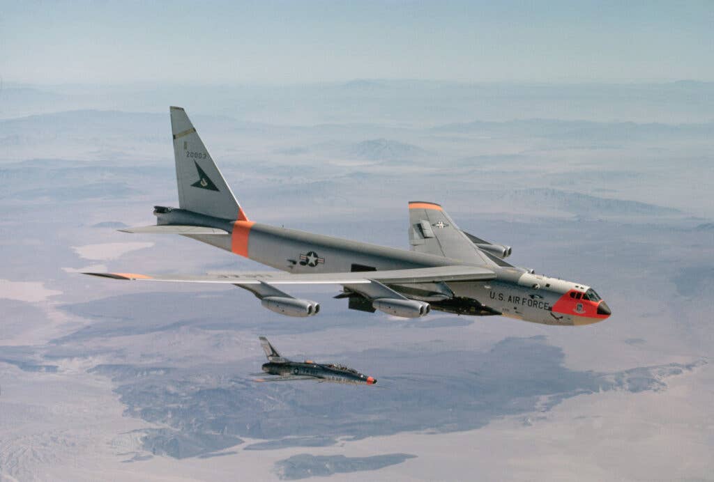 The NB-52A drops an X-15 rocket plane after carrying it to launching altitude for a test flight over Edwards Air Force Base in California. <em>Dean Conger/Corbis via Getty Images</em>