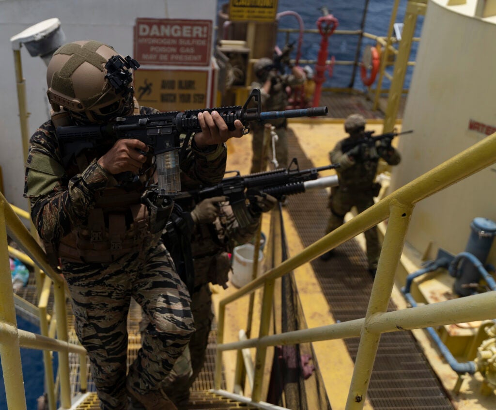 A member of the Philippine Navy Special Operations Group, U.S. Navy SEAL with Special Warfare Group, and an Australian Operator with 2nd Commando Regiment conduct maritime security operations during exercise Balikatan 22 off the coast of Palawan, Philippines, April 7, 2022. Balikatan is an annual exercise between the Armed Forces of the Philippines and U.S. military designed to strengthen bilateral interoperability, capabilities, trust and cooperation built over decades of shared experiences. Balikatan, Tagalog for 'shoulder-to-shoulder' is a longstanding bilateral exercise between the Philippines and the United States highlighting the deep-rooted partnership between both countries. BK22 is the 37th iteration of the exercise and coincides with the 75th anniversary of U.S. Philippine security cooperation. (U.S. Marine Corps photo by Sgt. Mario A. Ramirez)