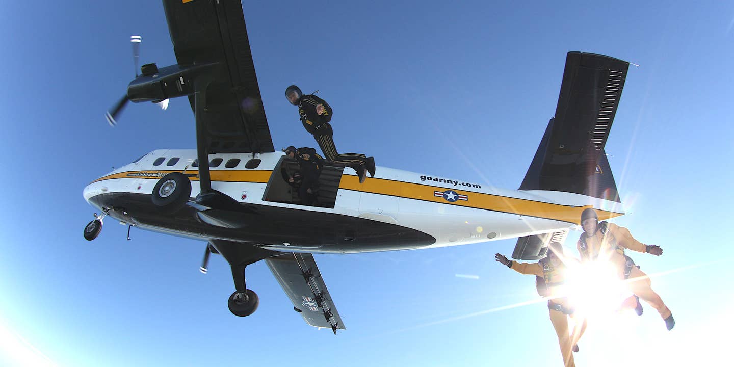 Members of the US Army's Golden Knights parachute demonstration team jump from a UV-18 Twin Otter aircraft.