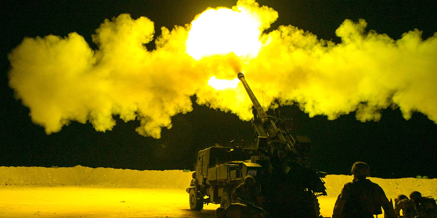 French soldiers, assigned to Task Force Wagram, conduct a fire mission in support of Operation Roundup, during the night in Al Qaim, Iraq May 16, 2018.