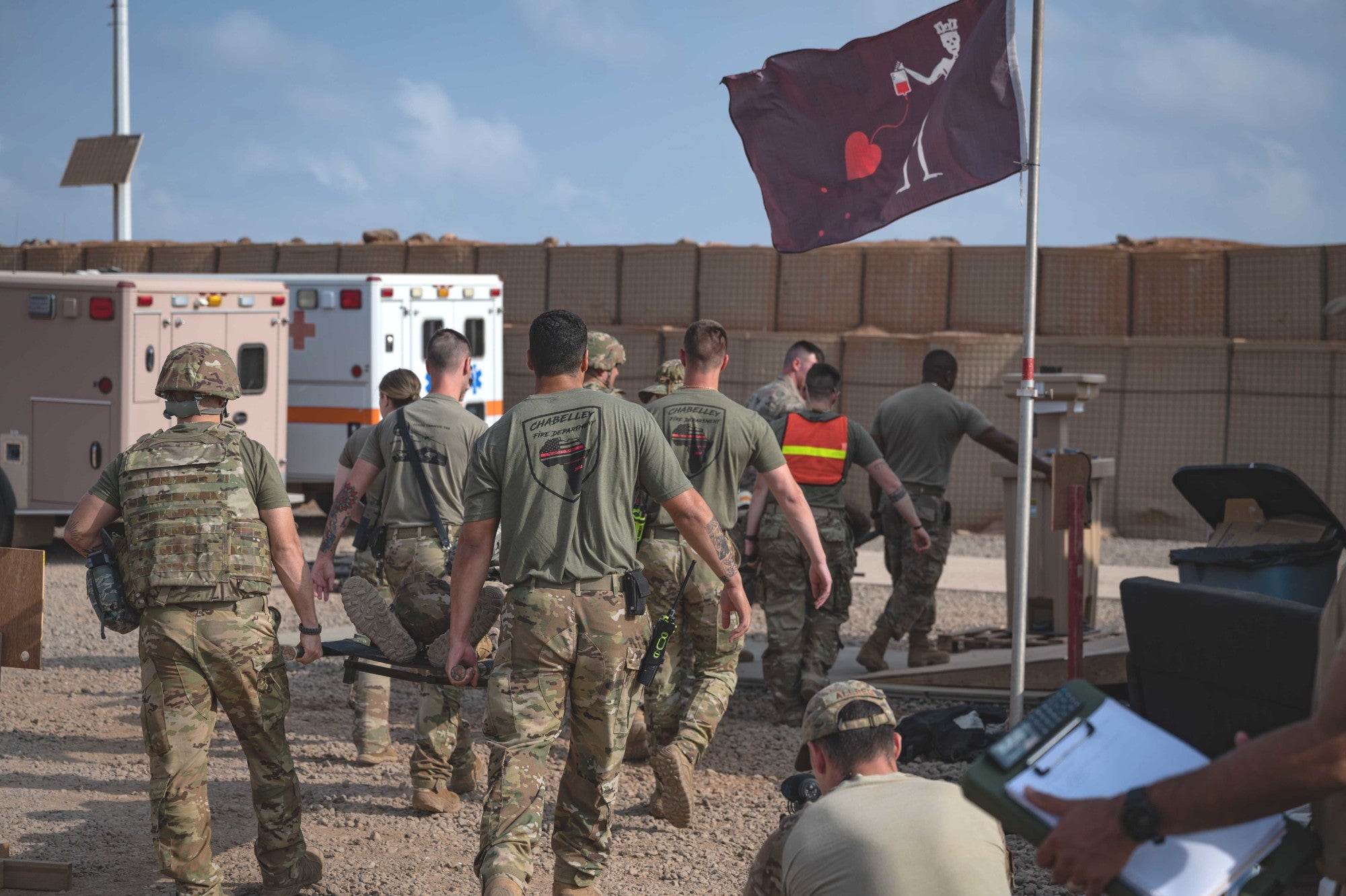 U.S. service members supporting Combined Joint Task Force - Horn of Africa, tend to simulated casualties during a mass casualty exercise at Chabelley Airfield, Djibouti, April 21, 2022. The exercise focused on coordination and communication between different units and mission partners in order to provide effective medical evacuation support for joint operations in the Horn of Africa. (U.S. Air Force photos by Staff Sgt. Joel Pfiester)