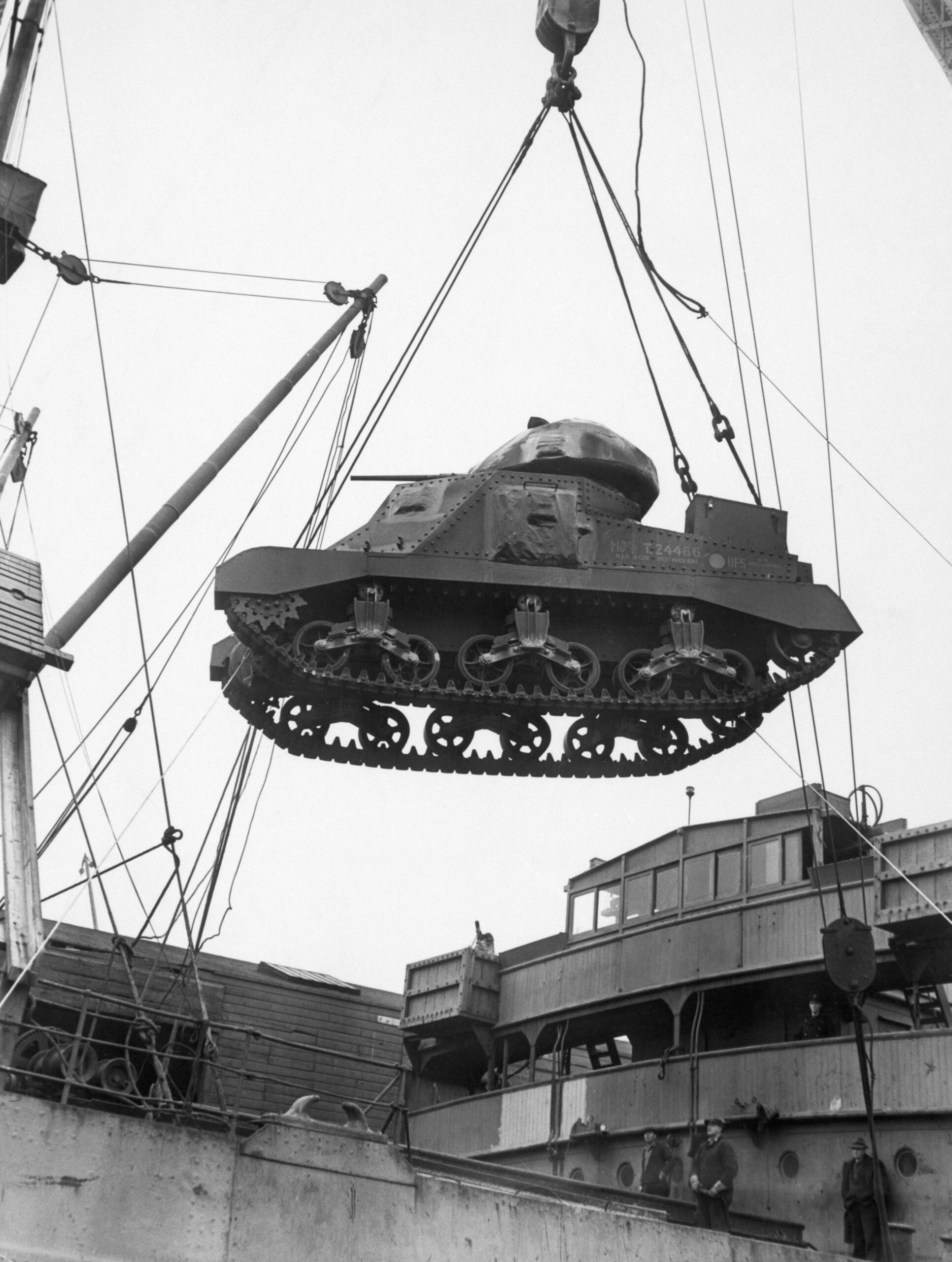 (Original Caption) A Lend lease tank coming over the side of a cargo ship in a U.S. Atlantic Coast port. World War II era photograph.