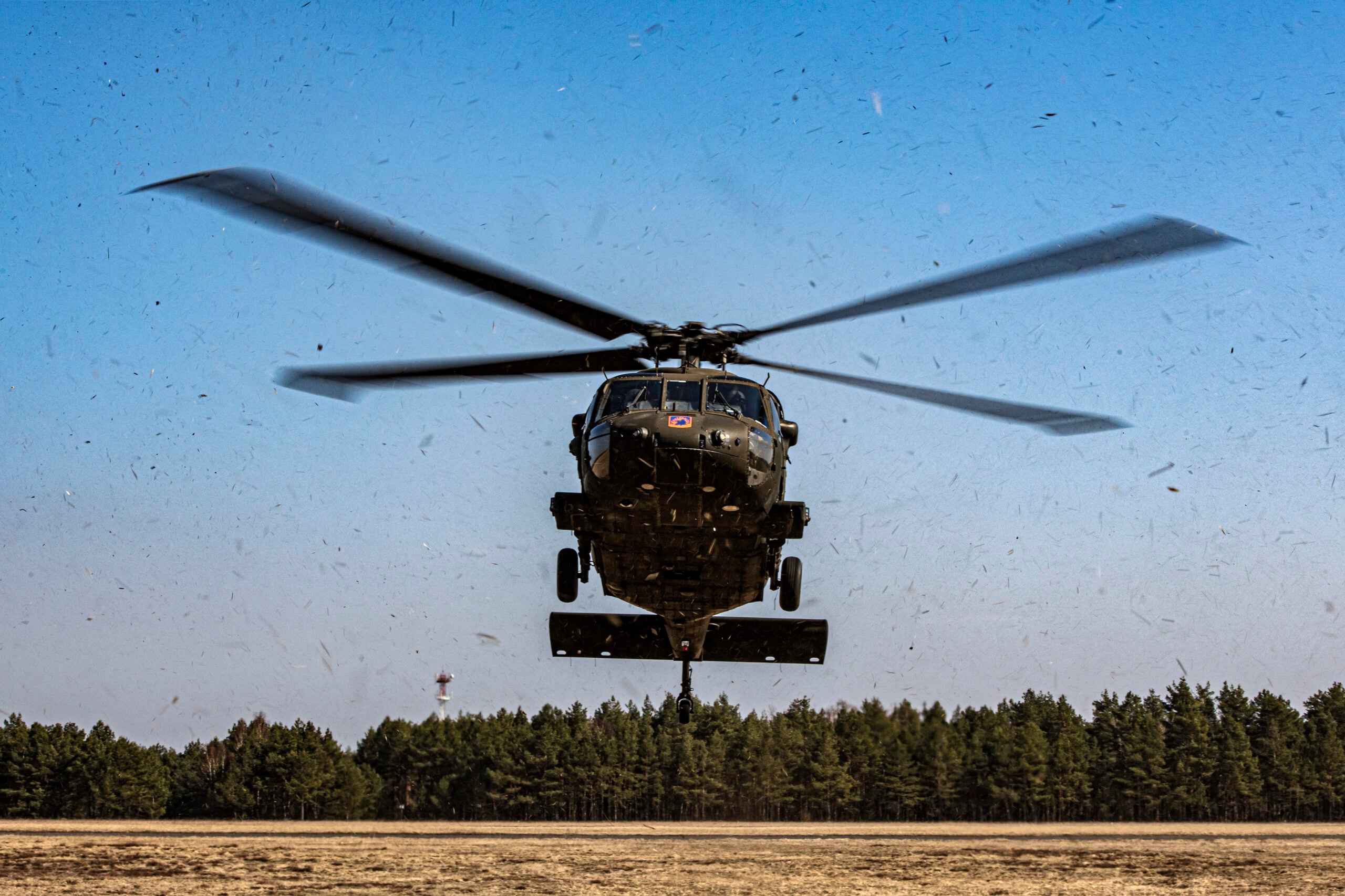 A UH-60 Blackhawk helicopter, from the U.S. Army 1-214th General Support Aviation Battalion, 12th Combat Aviation Brigade conduct individual and collective aerial gunnery qualification as part of a week-long training exercise at the Nadarzyce Training Area, Poland, March 25, 2022. The training allows air crews to enhance their proficiency with the M240H machine gun weapon system and improve their readiness to support casualty evacuation operations. The 12th CAB is among other units assigned to V Corps, America’s Forward Deployed Corps in Europe that works alongside NATO Allies and regional security partners to provide combat-ready forces, executes joint and multinational training exercises, and retains command and control for all rotational and assigned units in the European theater. (U.S. Army photo by Michele Wiencek).