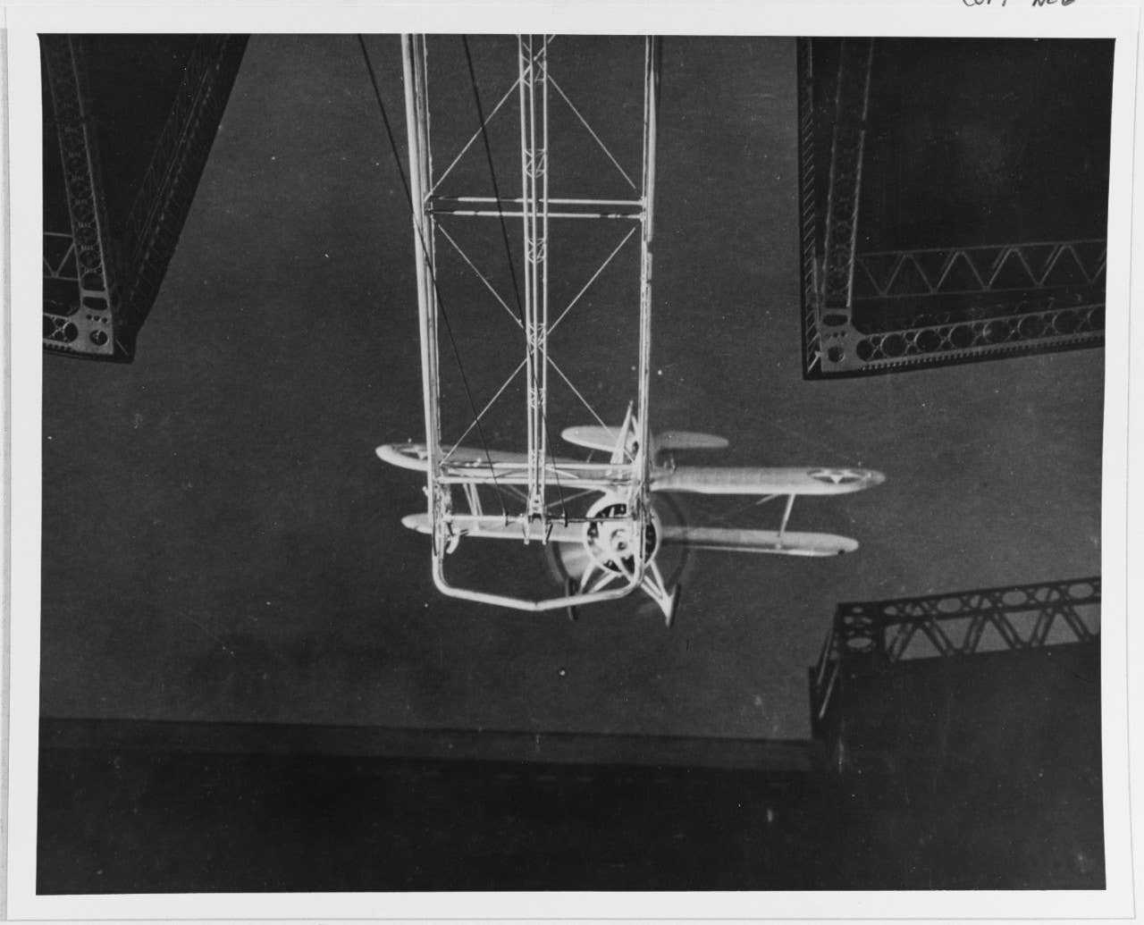 The view from inside the hangar as the XF9C-1 Sparrowhawk approaches the trapeze of USS <em>Akron</em>. <em>U.S. National Archive</em>s<br>