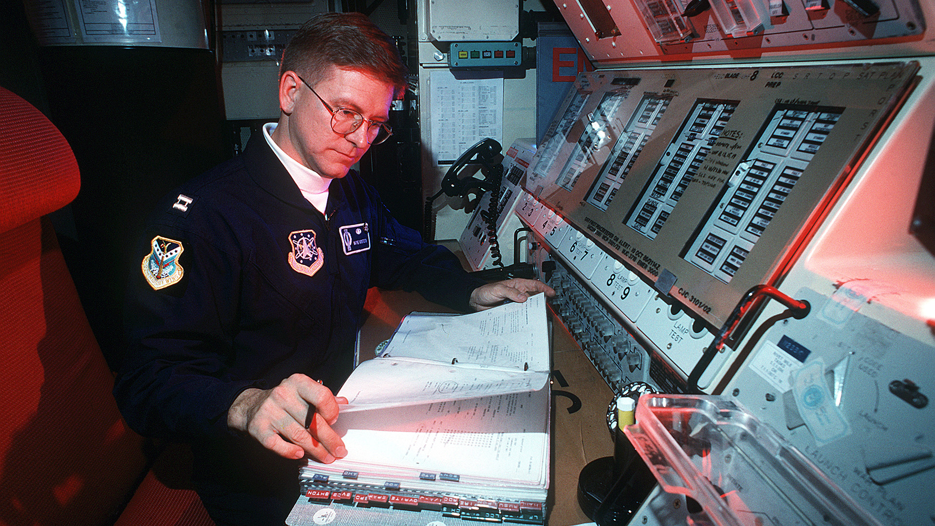 Capt. Wayne R. Monteith, 90th Operations Group, review procedures at the launch control station at one of the Peackeeper missile sites.