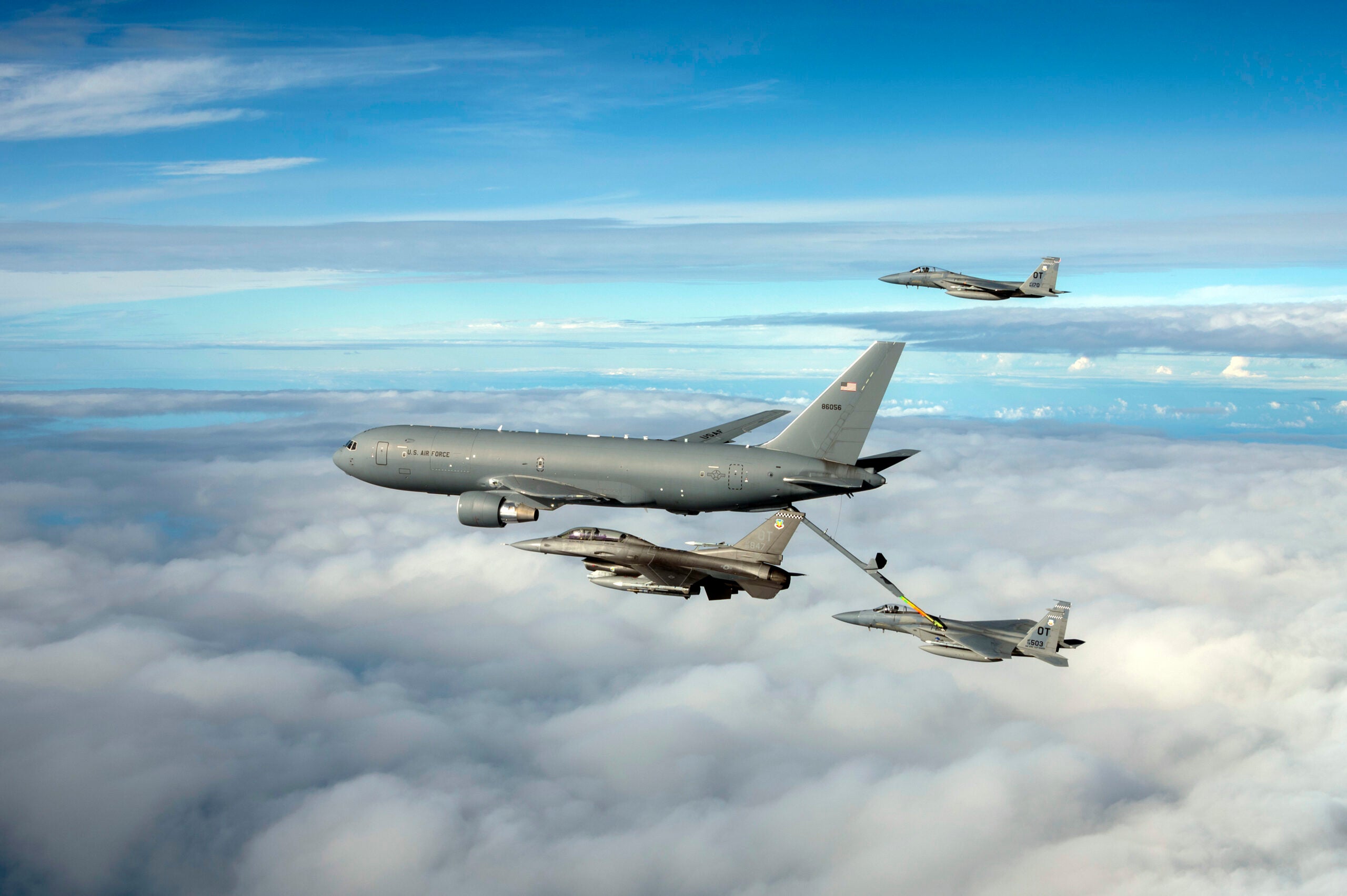 A KC-46 Pegasus assigned to the 931st Air Refueling Wing, McConnell Air Force Base, Kansas, refuels an F-15C Eagle while an F-16 Fighting Falcon and F-15C assigned to Eglin AFB, Florida, fly alongside over the Gulf of Mexico, Nov. 18, 2021. The aircraft were participating in Checkered Flag 22-1, a large-force aerial exercise held at Tyndall AFB, Florida, which fosters readiness and interoperability through the incorporation of fourth- and fifth-generation aircraft during air-to-air combat training. The 22-1 iteration of the exercise was held Nov. 8-19, 2021. (U.S. Air Force photo by Staff Sgt. Betty R. Chevalier)