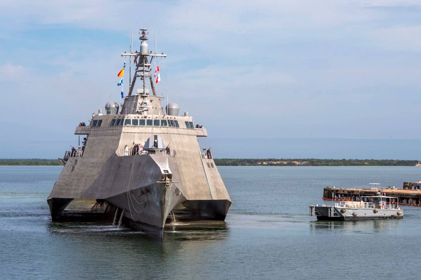 A Naval Station vessel, right, prepares to assist the future <em>USS Omaha</em> (LCS-12) pier side during a brief fuel stop in Guantanamo Bay, Cuba. <em>Mass Communication Specialist 1st Class John Philip Wagner, Jr./U.S. Navy via AP</em>