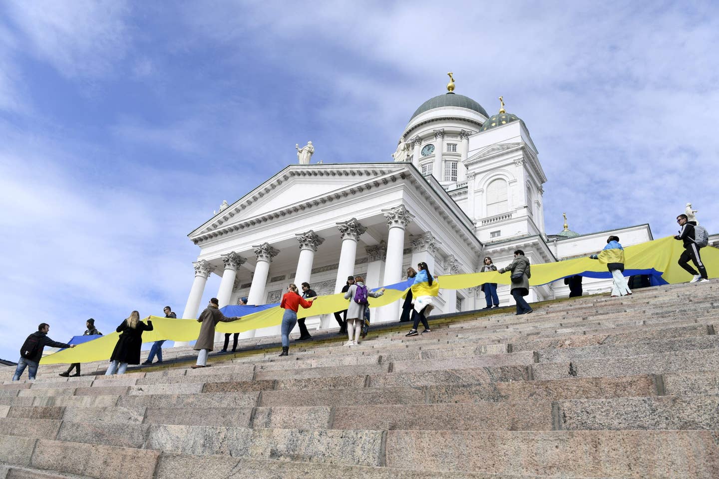 People show their support for Ukraine on the steps of Helsinki Cathedral in the Finnish capital, on April 18, 2022. <em>Photo by EMMI KORHONEN/Lehtikuva/AFP via Getty Images</em>