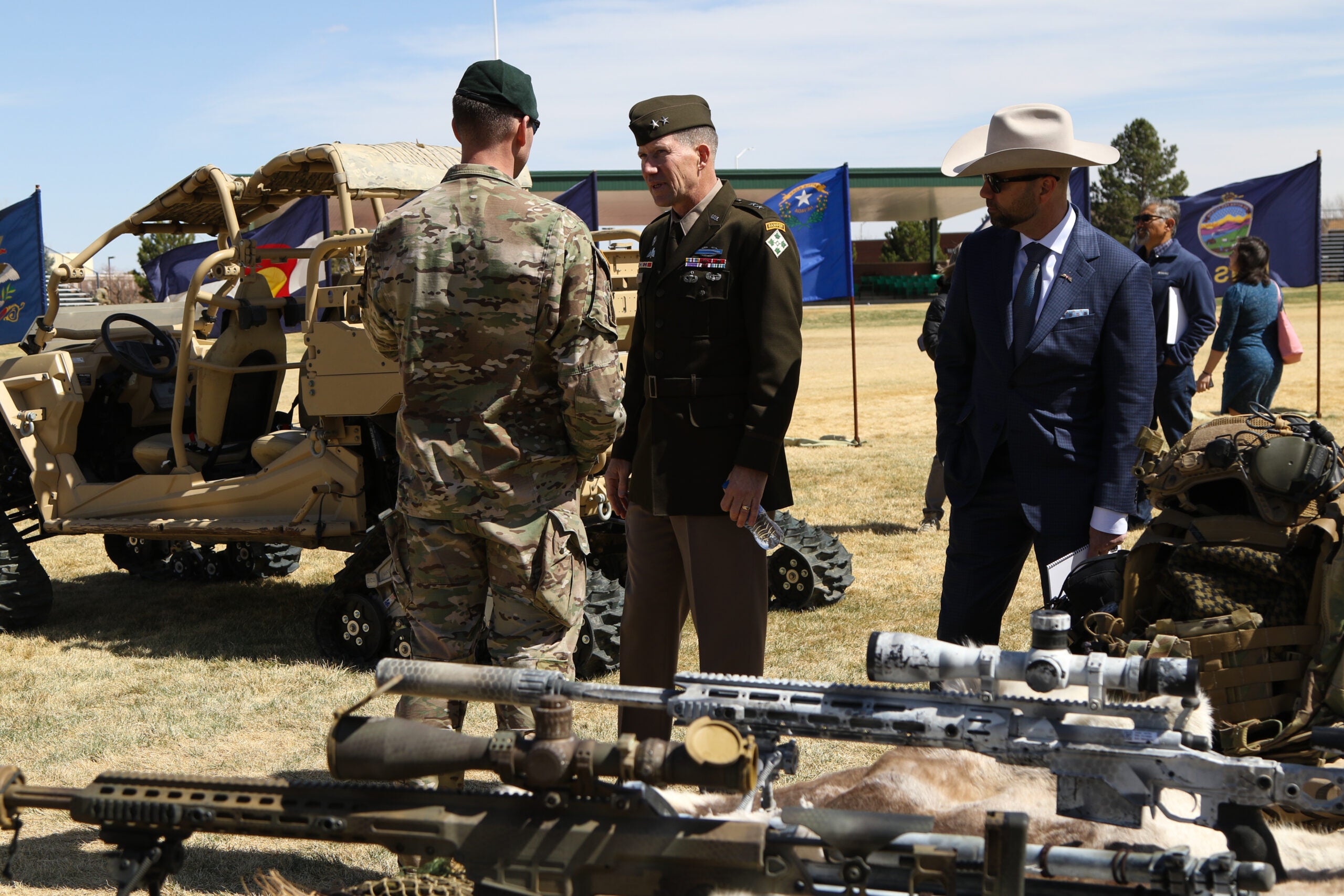 Maj. Gen. David Hodne, commanding general, 4th Infantry Division and Fort Carson, thanks a 10th Special Forces Group (Airborne) Soldier at the State of the Mountain Post Address, April 14, 2022, on Founders Field at Fort Carson, Colorado. 10th SFG (A) were one of the 12 displays for attendees to come and discuss what their units bring to the fight. (U.S. Army photo by Sgt. David Davidson)