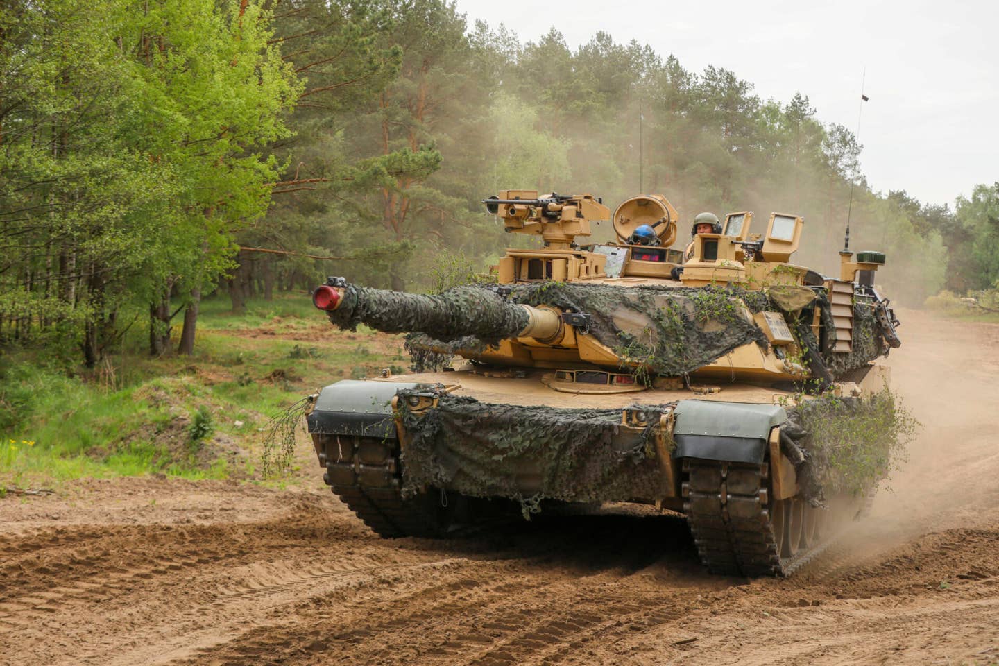 A U.S. Army M1A2 Abrams tank assigned to the 3rd Armored Brigade Combat Team, 4th Infantry Division, moves to their fighting positions during a multinational field exercise during Defender Europe 2022, Drawsko Pomorskie, Poland, May 15, 2022. (U.S. Army photo by Sgt. Andrew Greenwood)