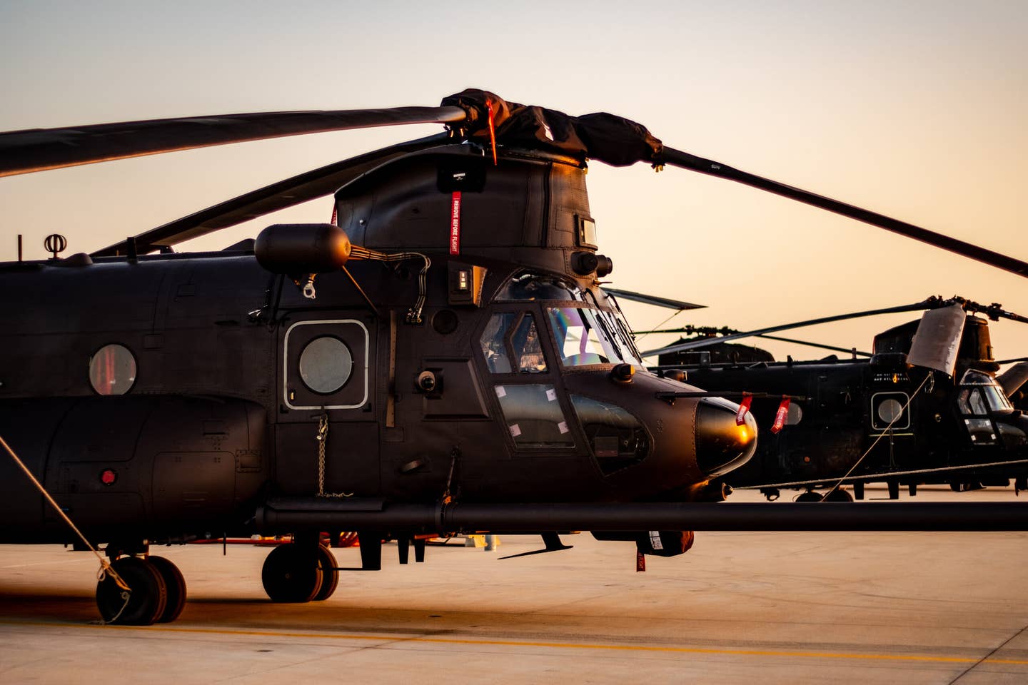 Three MH-47 Chinook helicopters at sunset at Point Mugu, California, in April. &nbsp;<em>Petty Officer 2nd Class Tyler Knotts</em>