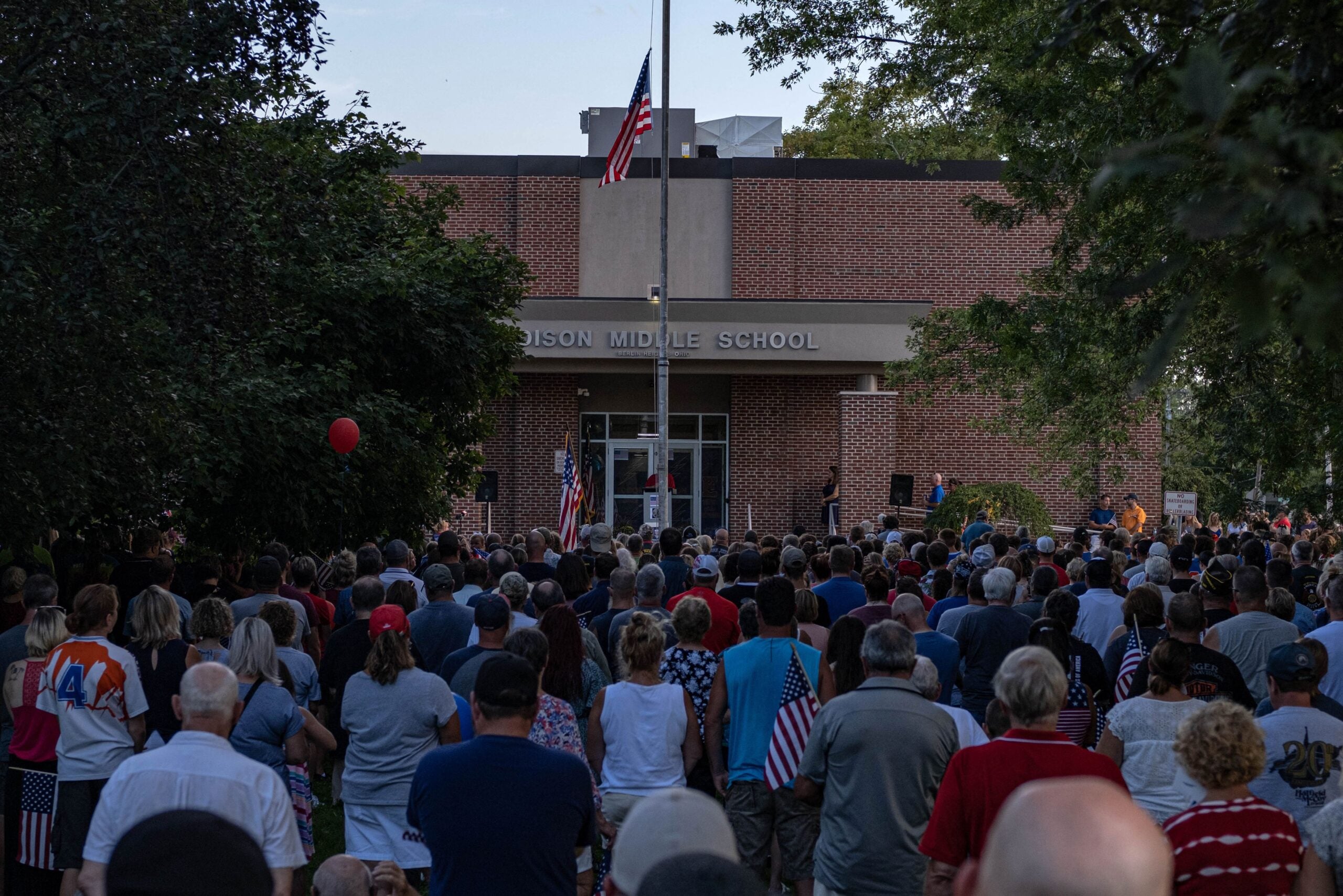 People attend a vigil for Navy Corpsman Maxton "Max" W. Soviak at Edison Middle School in Berlin Heights, Ohio on August 29, 2021. - Soviak was killed during the August 26 terror attack outside of Kabul Airport in Afghanistan along with 12 other American service members and more than 100 Afghans. (Photo by SETH HERALD / AFP) (Photo by SETH HERALD/AFP via Getty Images)