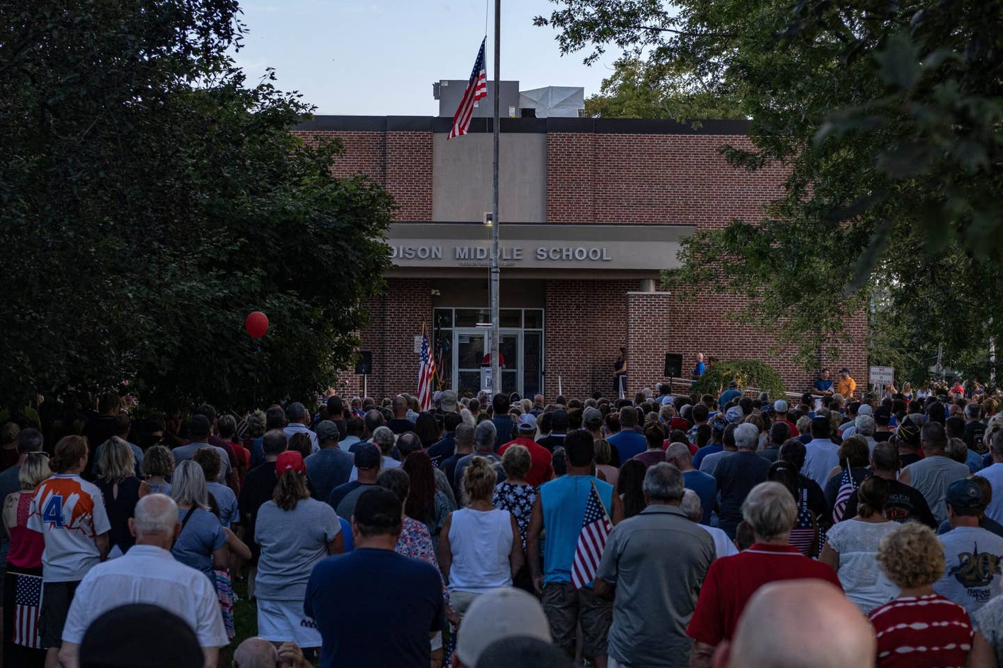 People attend a vigil for Navy Corpsman Maxton "Max" W. Soviak at Edison Middle School in Berlin Heights, Ohio on Aug. 29, 2021. Soviak was killed during the Aug. 26 terror attack outside of Kabul Airport in Afghanistan along with 12 other American service members and more than 100 Afghans. (Photo by SETH HERALD/AFP via Getty Images)