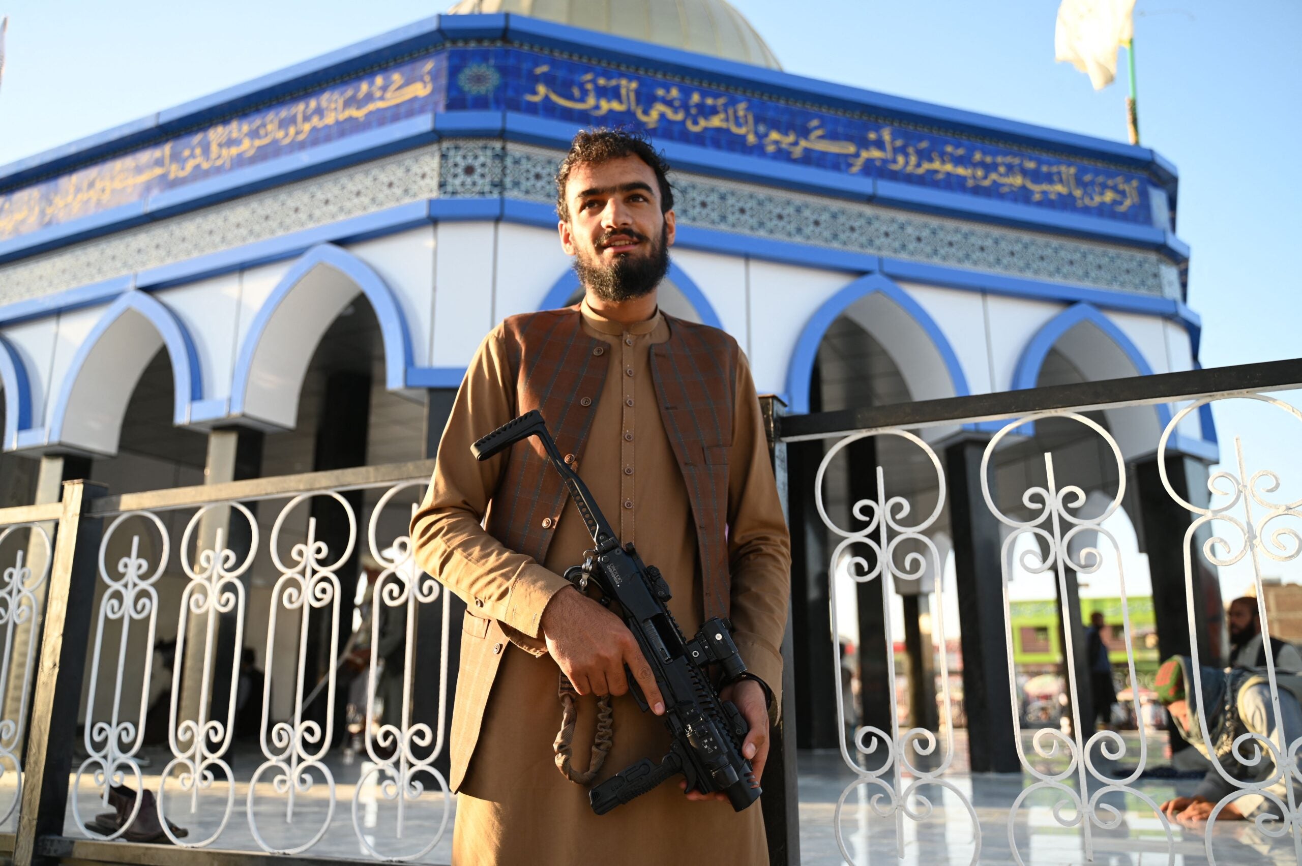 A Taliban fighter poses in front of a replica of Al-Aqsa Mosque at Kampani Square on the outskirts of Kabul on May 23, 2022. (Photo by Wakil KOHSAR / AFP) (Photo by WAKIL KOHSAR/AFP via Getty Images)