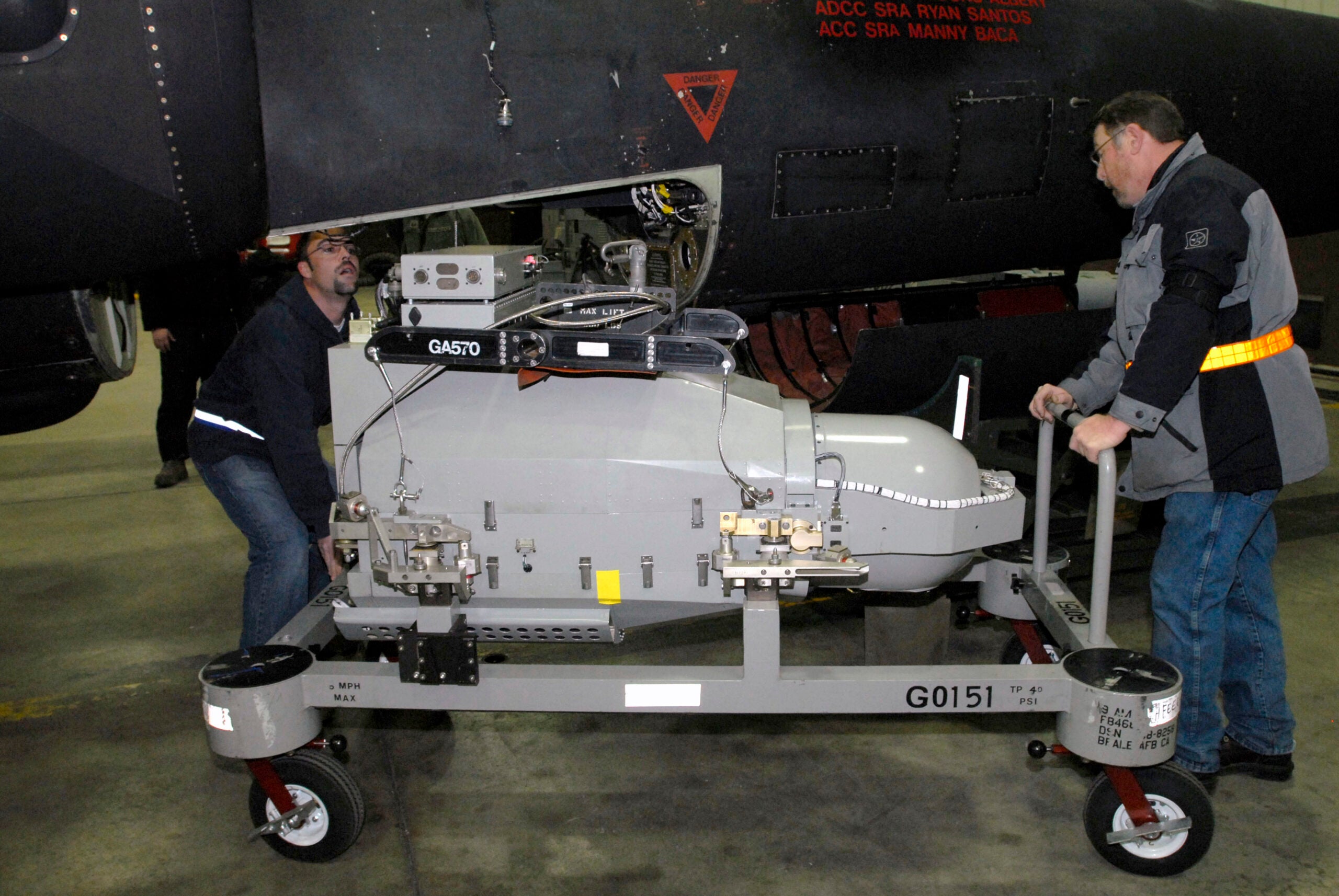 Ron Deagle (left) and Rod Blazvick prepare to load an optical bar camera into a U.S. Air Force U-2 high-altitude, all-weather surveillance and reconnaissance aircraft March 13, 2011, at Osan Air Base, South Korea. The U-2 is being prepared for a humanitarian mission to capture imagery of the earthquake- and tsunami-affected areas of Japan. (U.S. Air Force photo by Senior Master Sgt. Paul Holcomb)