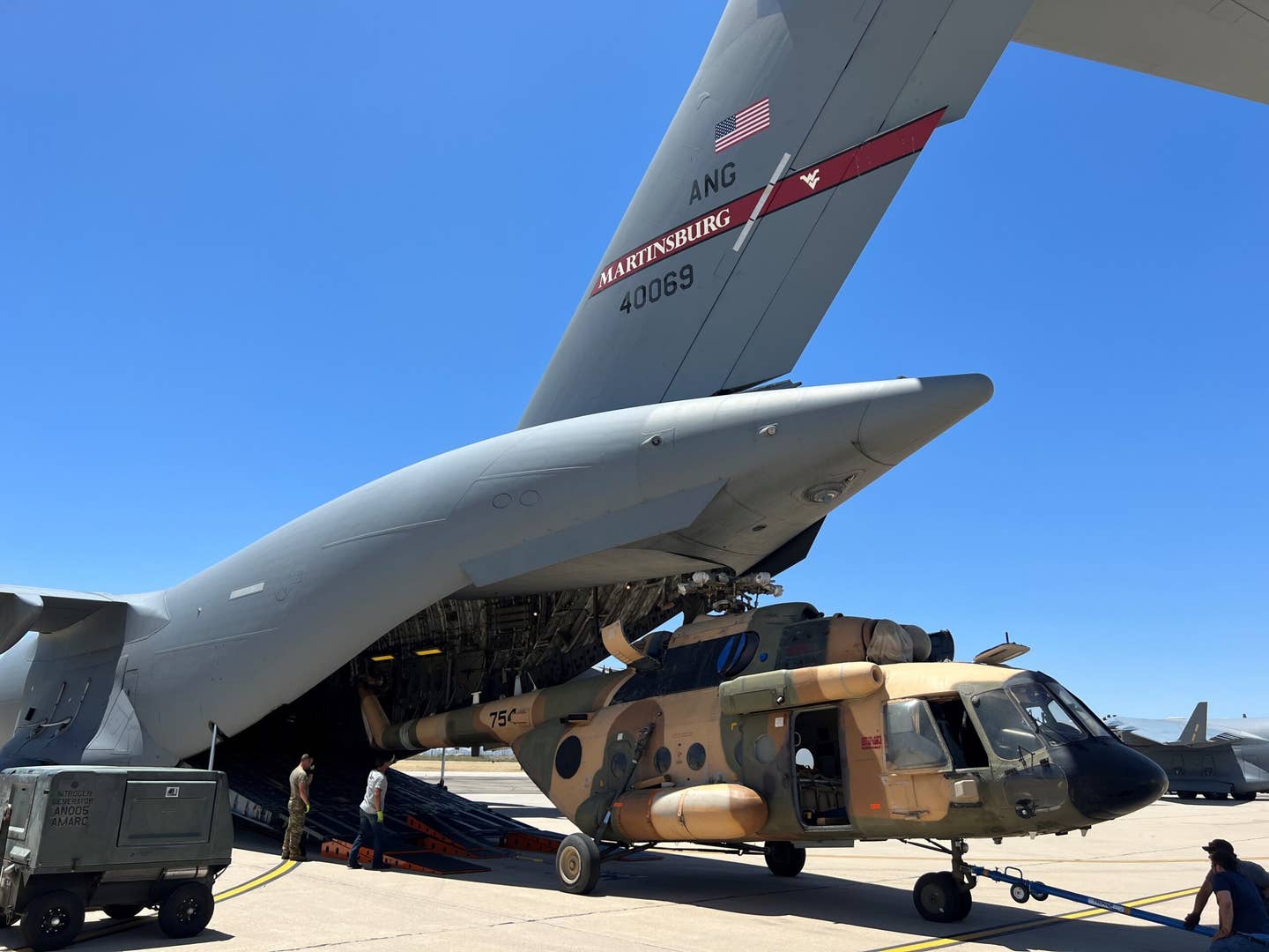 An Mi-17 helicopter bought for the Afghan Air Force is loaded onto a C-17 at Davis-Monthan for transport to Sliač Airport in Slovakia and on to Ukraine. <em>U.S. Air National Guard photo by Chief Master Sgt. Mark Snyder</em>
