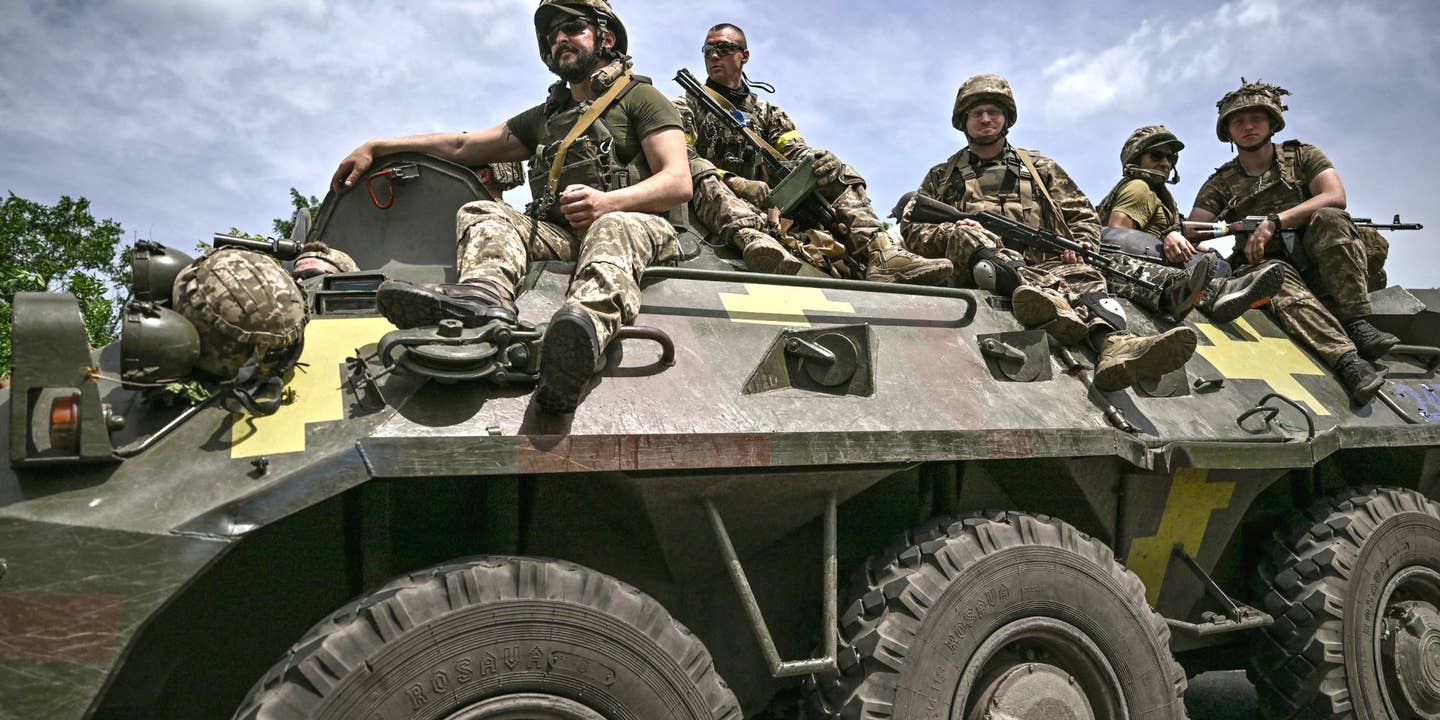 Ukrainian troops sit on an armoured vehicle as they move back from the front line near the city of Sloviansk in the eastern Ukrainian region of Donbas on June 1, 2022.
