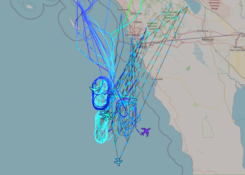 A view of the density of air activity off the coast of Mexico's Baja California Peninsula as visible through online flight tracking software at around 10:15 PM local time on June 6. The dotted lines represent periods of incomplete data and do not reflect actual routes taken by any of the aircraft. <em>ADS-B Exchange</em>