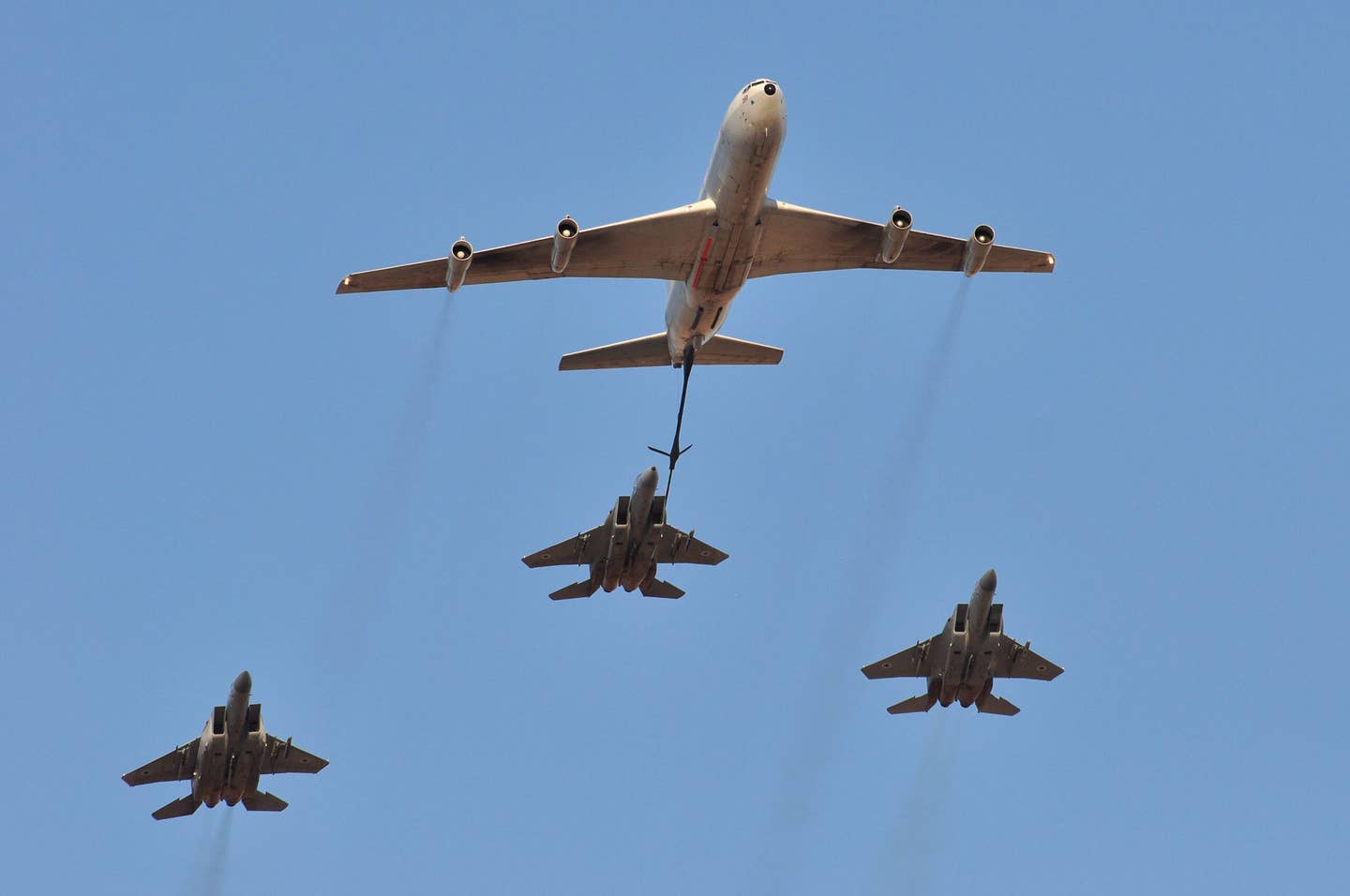 One of the Israeli Air Force’s Boeing 707-based tankers demonstrates the refueling of a trio of F-15s. <em>Yonatan Zalk/Israeli Air Force</em>