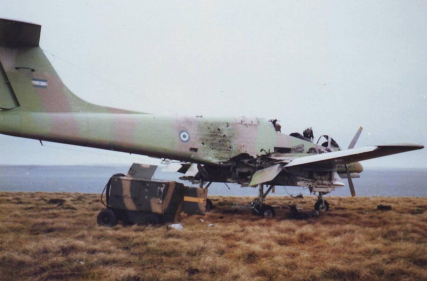 An Argentine Air Force Pucara that was destroyed by the SAS, at Pebble Island after the war. <em>Ken Griffiths/Wikimedia Commons</em>