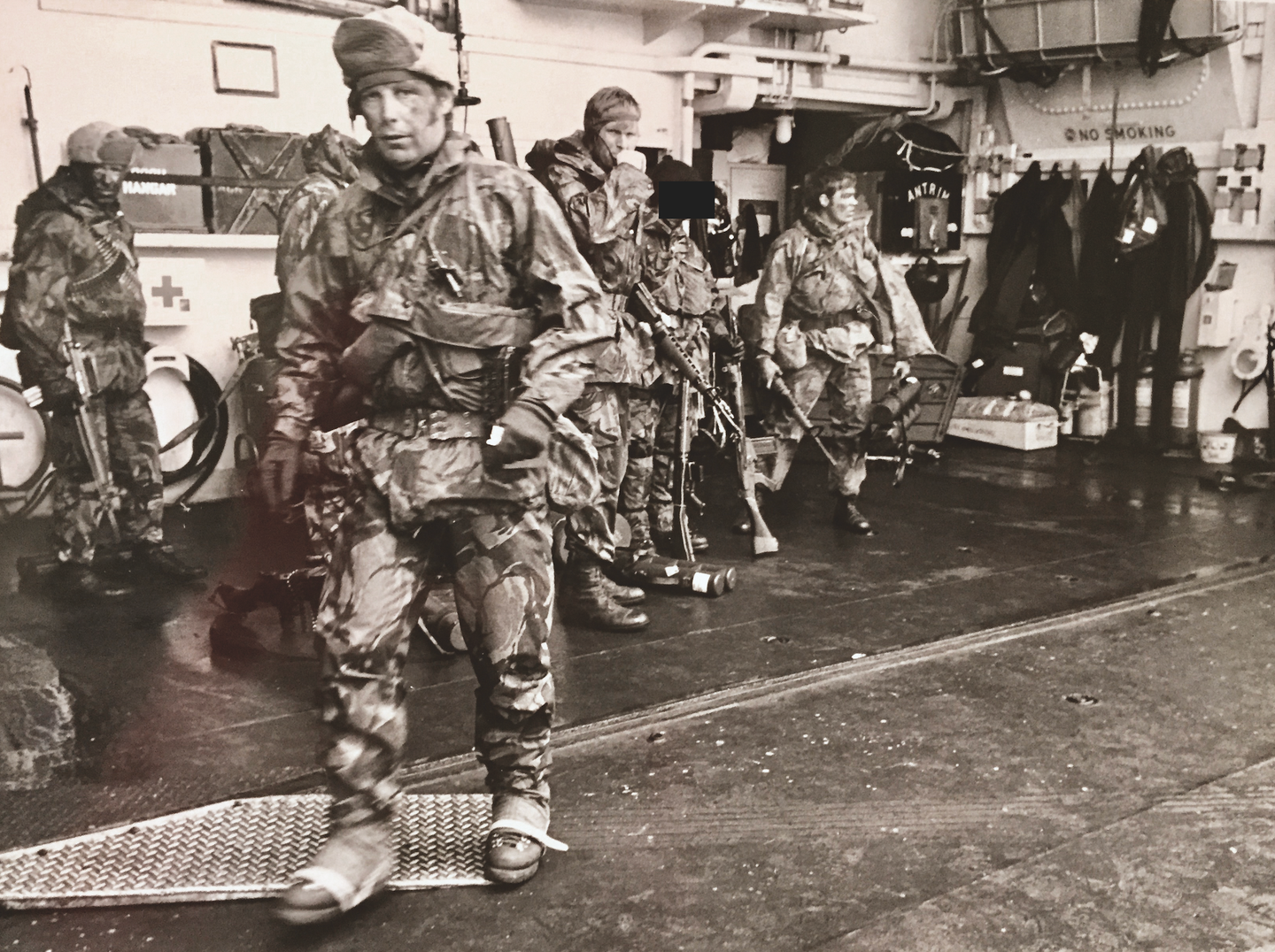 Onboard HMS <em>Antrim</em> shortly before launching the raid on Pebble Island. Splash is on the very left of the picture, with an AR-15 assault rifle in his right hand. Note the non-standard boots worn by the trooper in the foreground. <em>NA</em>