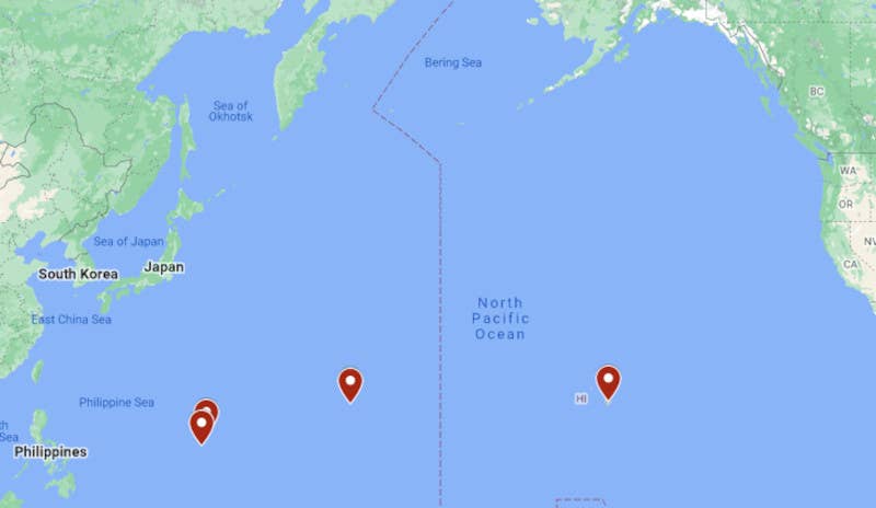 A map giving a very general sense of the distances at play between the locations in question, which also underscores their strategic significance. In the far western Pacific are Guam and Tinian (as well as Saipan), with Wake Island and then Hawaii further to the east. The vertical dotted line shown on the map is the International Date Line. <em>Google Maps</em>
