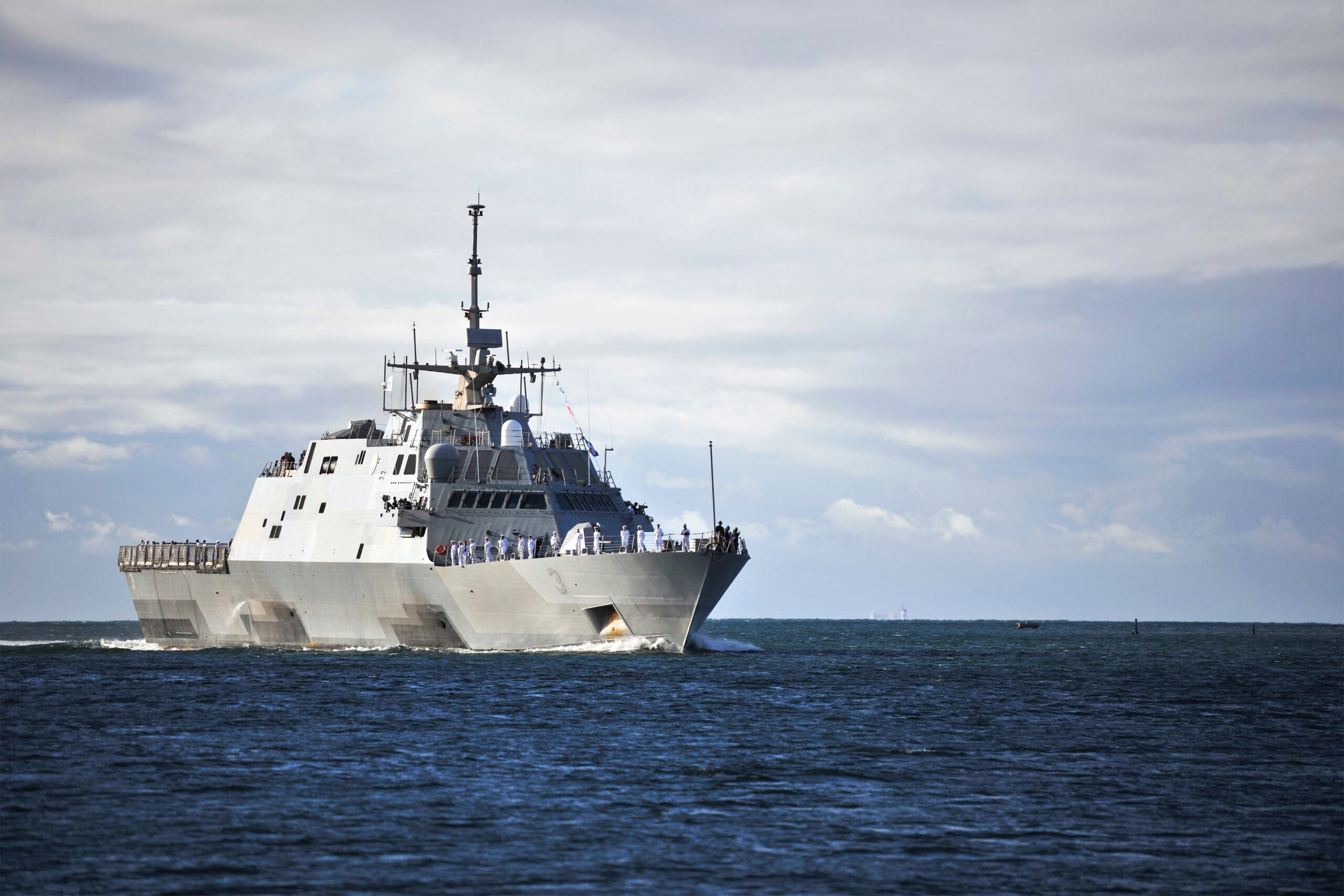 The littoral combat ship USS Fort Worth (LCS 3) arrives to Joint Base Pearl Harbor-Hickam for a scheduled port visit. Fort Worth deployed for a scheduled 16-month rotational deployment to Singapore in support of the Navy's strategic rebalance to the Pacific. Fort Worth is the first littoral combat ship to deploy under the 3-2-1 manning concept, swapping fully trained crews roughly every four months and extending the littoral combat ship forward presence. (U.S. Navy photo by Mass Communication Specialist 2nd Class Diana Quinlan/Released)