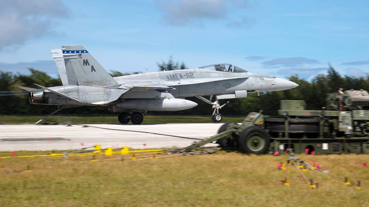 A US Marine Corps F/A-18 Hornet 'catches the wire' at Tinian International Airport during a past exercise. <em>USMC / Lance Cpl. J. Gage Karwick</em>