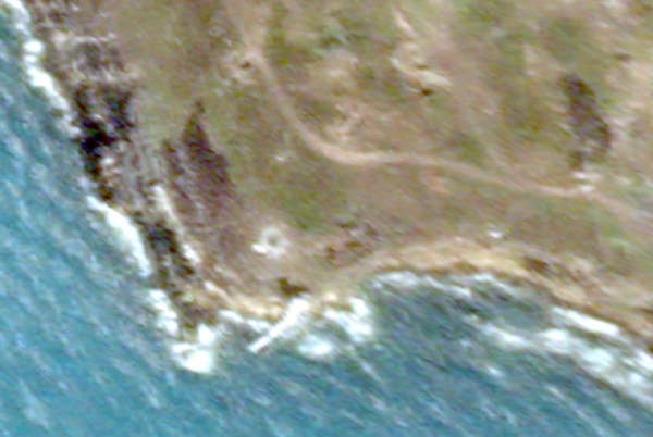 Two other scorched areas, seen on the right and left in this close up, are visible at the southern end of the island in the satellite image from June 21.