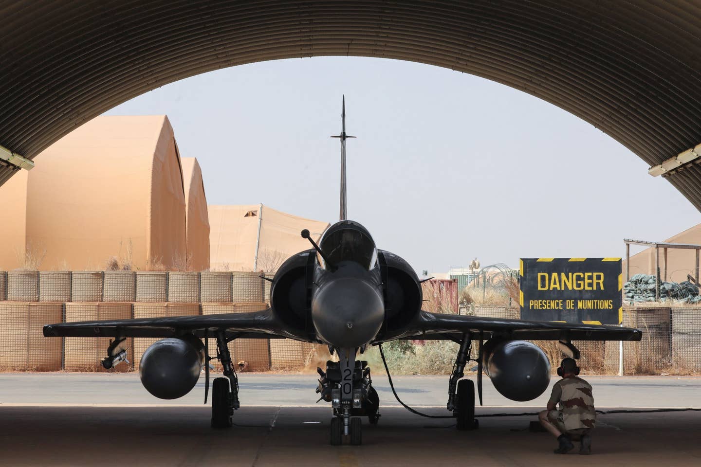 A technician works on a Mirage 2000C before it launches from the Niamey Air Base, Niger, in December 2017, to participate in a Barkhane mission in the Sahel region. <em>Photo by LUDOVIC MARIN/AFP via Getty Images</em>
