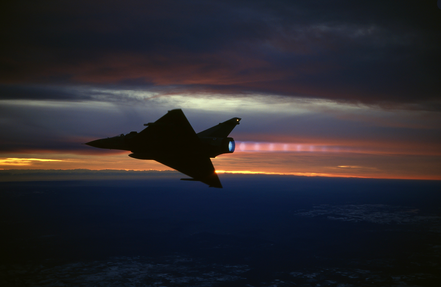 A stunning photo of a Mirage 2000C pulling away from its wingman in afterburner during a night mission. <em>Ian Black</em>