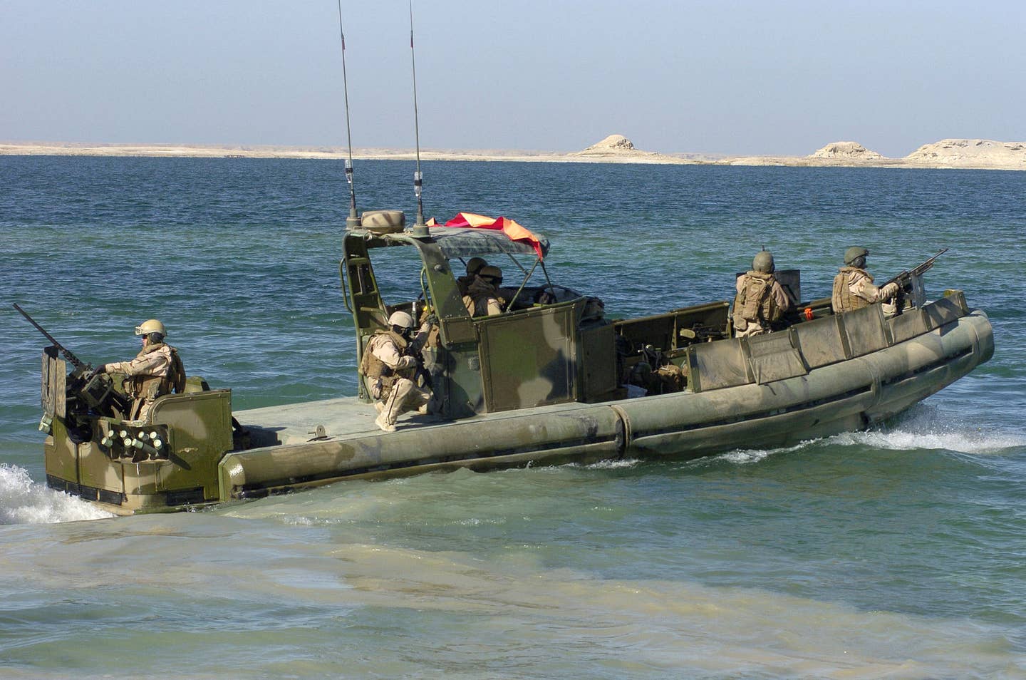 Riverines attached to Riverine Squadron 2 in a SURC at Haditha Dam Forward Operating Base conduct a patrol in Haditha, Iraq, December 20, 2007. Members of RIVRON 2 patrol Haditha’s dam and surrounding waterways, denying their use by insurgents, which in turn provides security to local fisherman. Location: Haditha Dam FOB, Anbar Province Iraq. (United States Navy, MC2 Kirk Worley)<br>