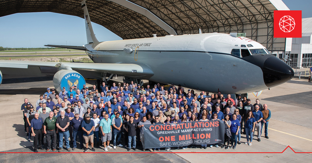 Workers from L3Harris standing in front of the first WC-135R. <em>Credit: L3Harris</em>