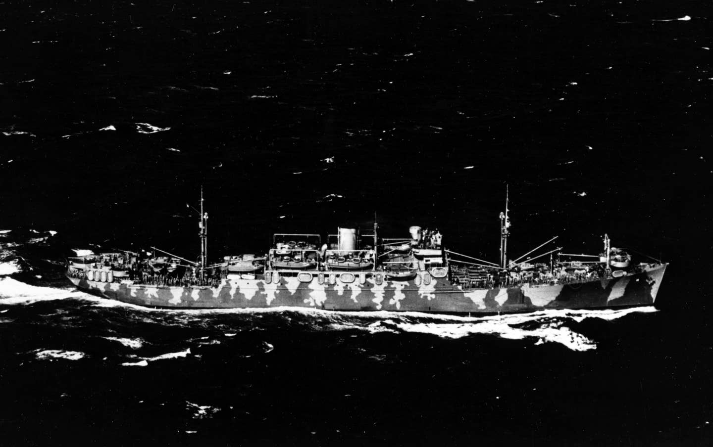 Wearing camouflage, the troop transport USS&nbsp;<em>Neville</em>&nbsp;(AP-16) is seen underway with a convoy in the Atlantic Ocean, in February 1942. <em>U.S. Navy</em>