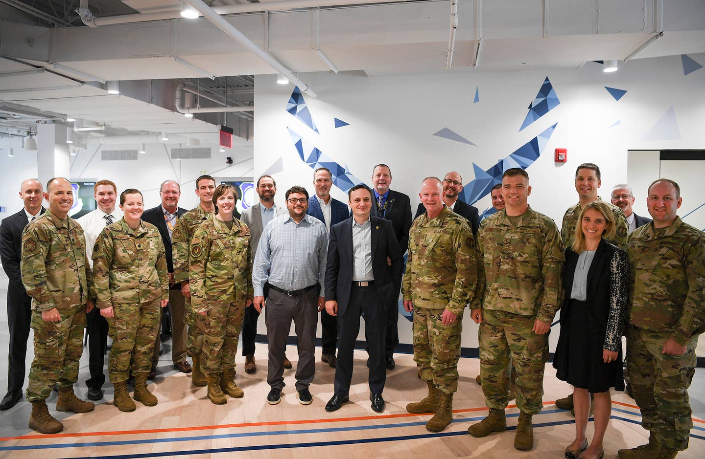 Nicolas Chaillan, center, the then Air Force chief software officer, poses for a group photo during a visit to the Hanscom Air Force Base, Massachussetts. <em>U.S. Air Force photo by Lauren Russell</em>