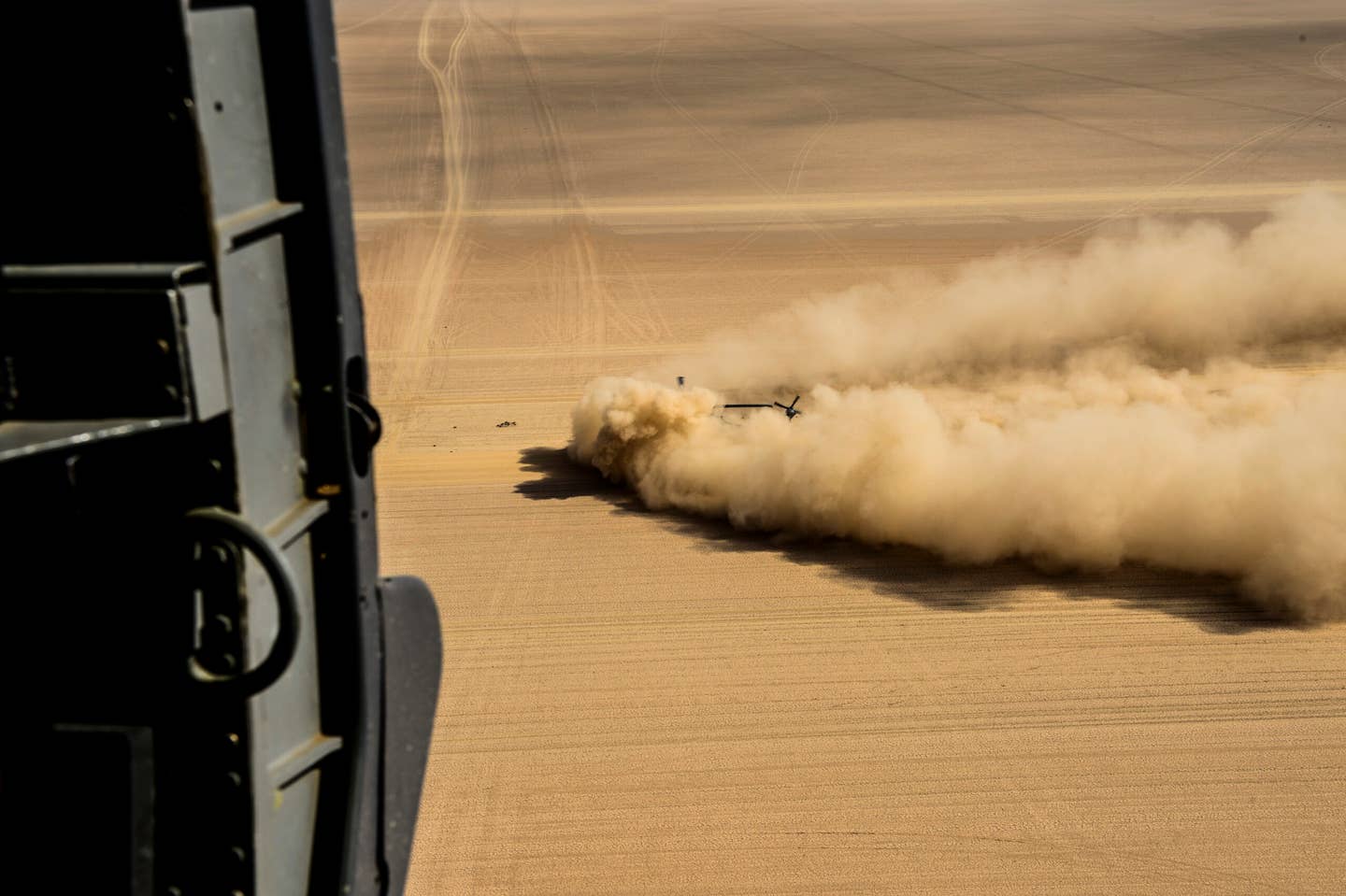 An Air Force HH-60 Pave Hawk is engulfed by a cloud of sand and dust during brownout training. <em>U.S. Air Force photo by Staff Sgt. Paul Labb</em>e