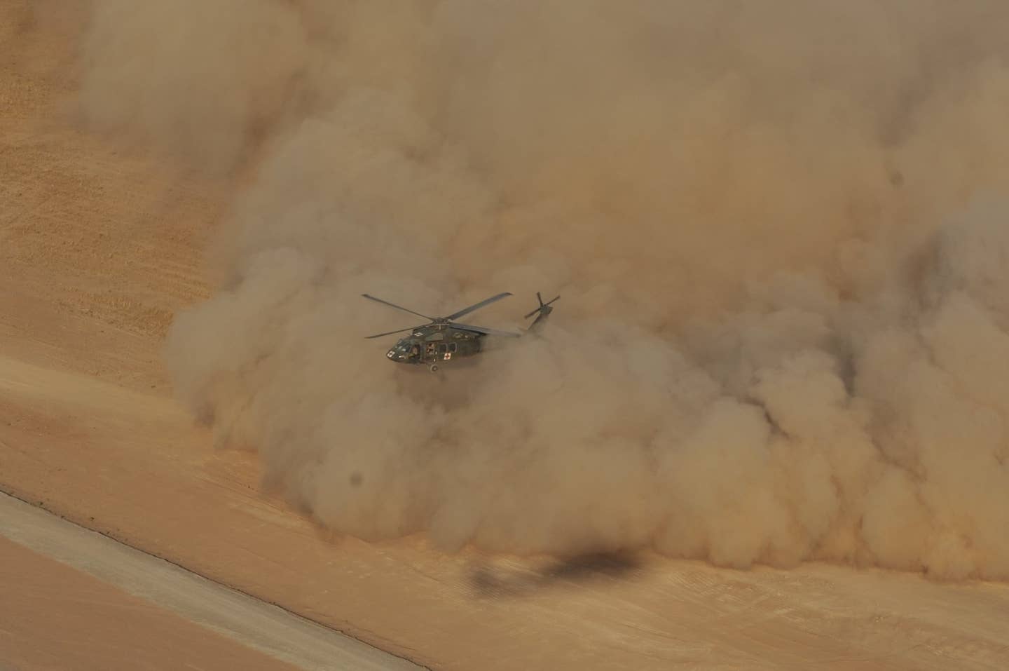An UH-60 Black Hawk medevac helicopter, without a DVEPS, lands in brownout conditions. <em>U.S. Army Photo by Maj. Allen Hill</em>