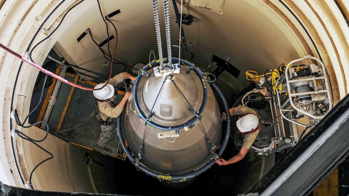 US Air Force personnel work on an LGM-30G Minuteman III missile in its silo. <em>USAF</em>