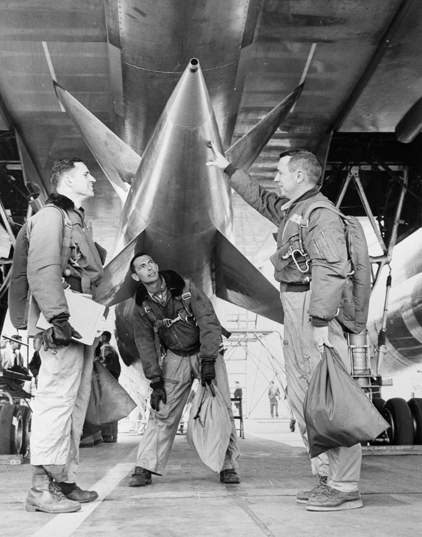 A flight-test crew inspects the detachable pod on a B-58, at the Convair plant in Fort Worth, Texas, in 1957. From left to right are the Defensive System Operator, test engineer, and pilot. <em>Photo by Metro/BIPs/Getty Images</em>
