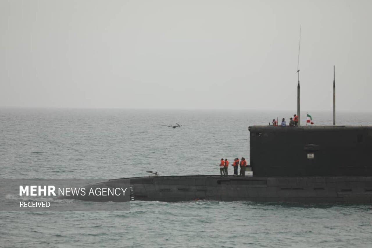Two Iranian drones can be seen launching from or near the submarine's dry deck. <em>MEHR News Agency</em>