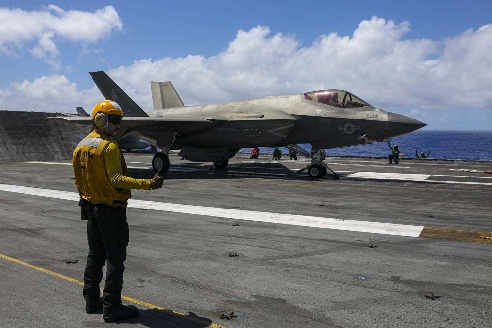 An F-35C Lightning II of Marine Fighter Attack Squadron 314 "Black Knights" (VMFA-314) readies for launch from the USS <em>Abraham Lincoln </em>during a SINKEX at RIMPAC 2022. (DVIDS/MC3 Javier Reyes).