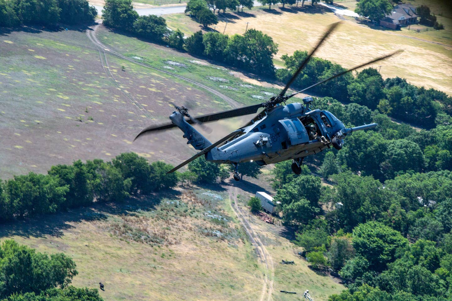 A U.S. Air Force HH-60W Jolly Green II, from the 41st Rescue Squadron, conducts air combat maneuvers in the skies of Lancaster, Texas, June 29, 2022. This week-long training was the first time the 41st RQS executed training air combat maneuvers with the HH-60W Jolly Green II helicopter against an Mi-24 Hind. (U.S. Air Force photo by Airman 1st Class Courtney Sebastianelli)