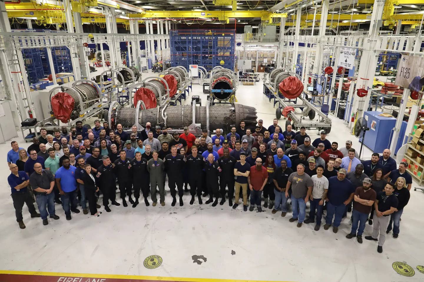 Members of the Oklahoma City Air Logistics Complex Heavy Maintenance Center pose for a group photo with the Air Force’s F-35A Demonstration Team during their visit to Tinker Air Force Base, Oklahoma, on May 25, 2021.,&nbsp;<em>U.S. Air Force/Paul Shirk</em>