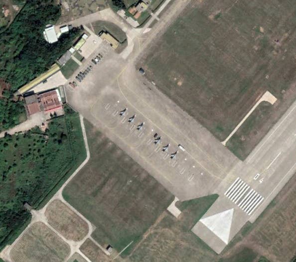J-7 fighter jets parked right off the southern end of the main runway at Longtian in 2018. <em>Google Earth</em>