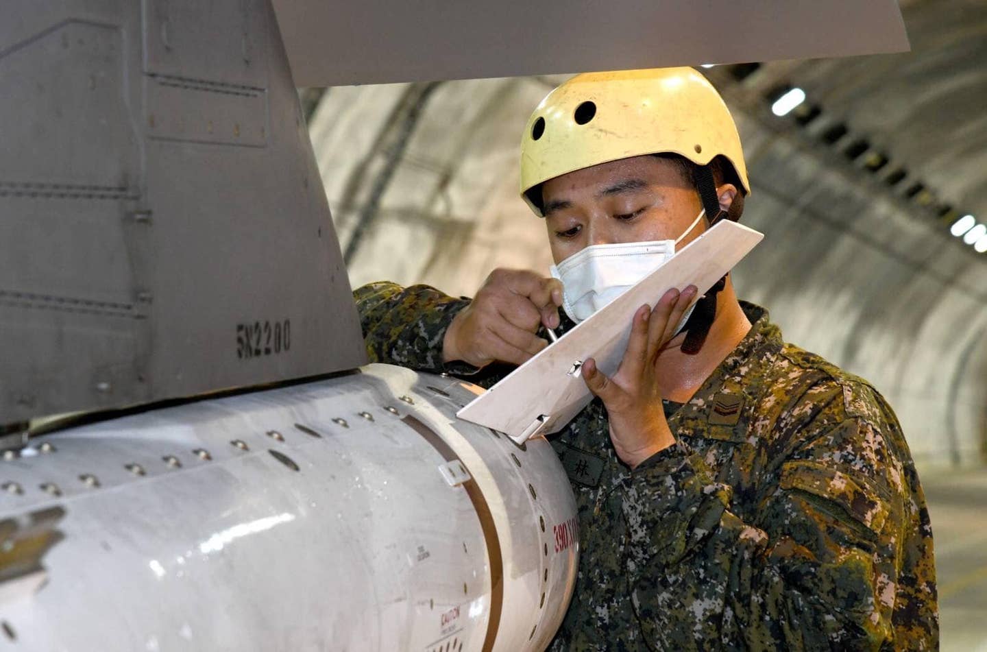 A ROCAF crewmember in Chiashan's underground hangar during a weapons loading exercise. <em>Credit: ROCAF</em>