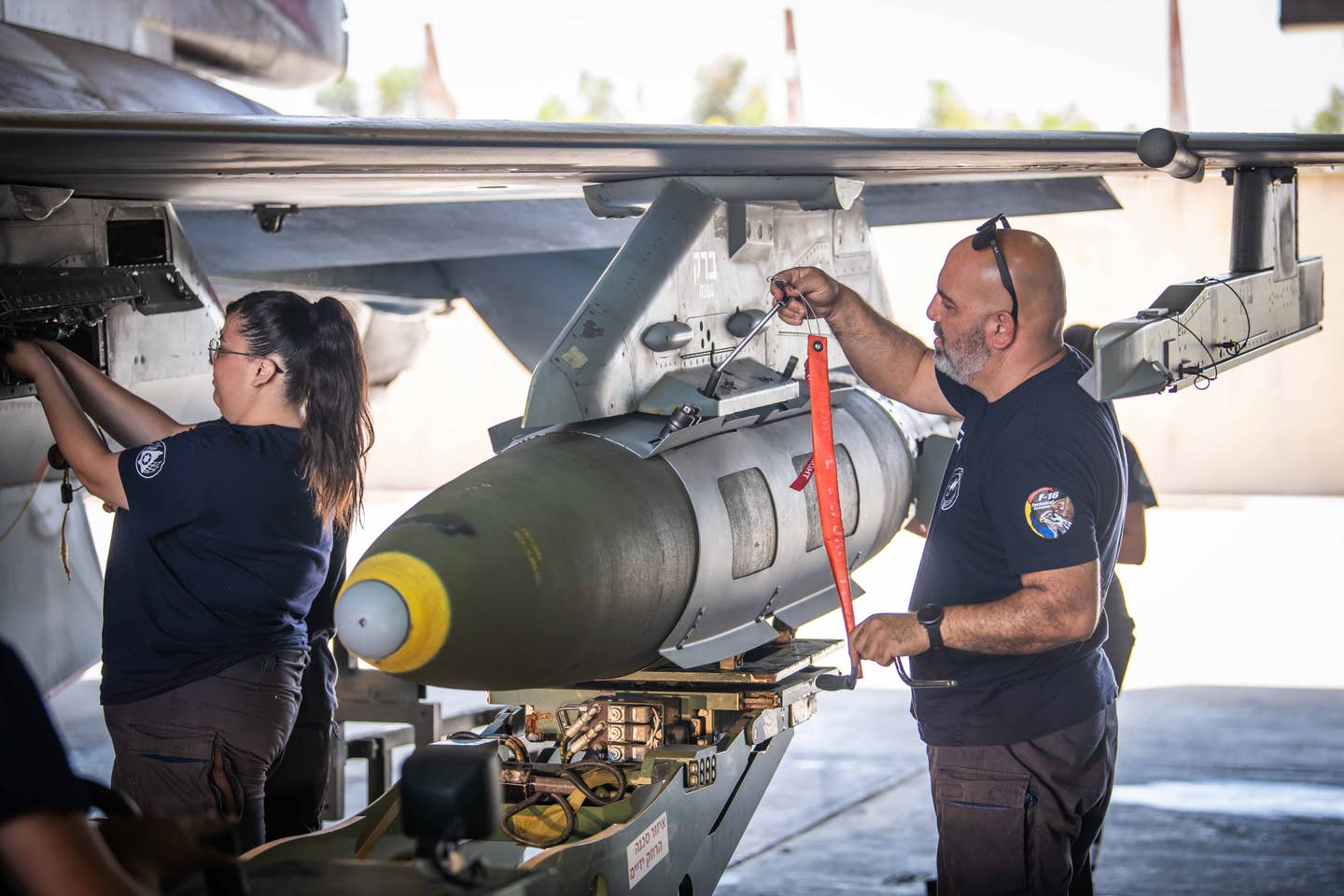 IAF technicians prepare an F-16 loaded with a Joint Direct Attack Munition, ahead of a sortie during Operation Guardian of the Walls over Gaza in 2021. <em>IAF</em>